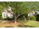 Inviting front exterior featuring a well-manicured lawn and mature trees, with great curb appeal at 5628 Harbormist Dr, Powder Springs, GA 30127