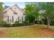 Inviting home with a well-kept yard, complemented by mature trees and fresh landscaping at 5628 Harbormist Dr, Powder Springs, GA 30127