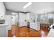 This eat-in kitchen with all-white cabinets, stainless appliances, and a center island flows into the dining area at 5628 Harbormist Dr, Powder Springs, GA 30127
