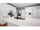 Bright kitchen boasts white cabinetry, stainless appliances, a center island, and modern finishes at 5628 Harbormist Dr, Powder Springs, GA 30127