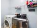 Clean laundry room with washer, dryer, and wire shelving for storage at 5628 Harbormist Dr, Powder Springs, GA 30127