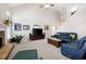 Spacious living room with a stone fireplace, neutral carpet, and natural light from a large window at 5628 Harbormist Dr, Powder Springs, GA 30127