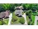 Aerial view showcasing the home's well-manicured lawn and lush surrounding greenery at 7020 Grassmoor Grange Way, Cumming, GA 30040