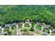 Aerial view of home with tree-lined backyard providing privacy in a serene residential neighborhood at 7020 Grassmoor Grange Way, Cumming, GA 30040