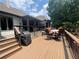 Spacious deck with a retractable awning, outdoor dining set, and grill, creating an ideal entertaining space at 7020 Grassmoor Grange Way, Cumming, GA 30040