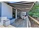 Back deck featuring a retractable awning and outdoor seating for entertaining at 7020 Grassmoor Grange Way, Cumming, GA 30040