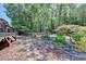 A landscaped backyard complete with a stone path, decorative trees and a swing set, perfect for outdoor enjoyment at 7020 Grassmoor Grange Way, Cumming, GA 30040