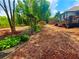 Beautifully landscaped backyard with stone pathway and wooded views at 7020 Grassmoor Grange Way, Cumming, GA 30040