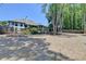 A serene backyard showcasing mature trees, landscaping, and ample room for outdoor living at 7020 Grassmoor Grange Way, Cumming, GA 30040