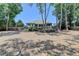A serene backyard showcasing mature trees, landscaping, and ample room for outdoor living at 7020 Grassmoor Grange Way, Cumming, GA 30040