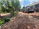 Landscaped backyard with a stepping stone path leading to the deck and a charming pergola feature at 7020 Grassmoor Grange Way, Cumming, GA 30040