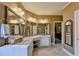 Bathroom featuring a large vanity area with three large mirrors and white cabinetry at 7020 Grassmoor Grange Way, Cumming, GA 30040