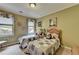 Bedroom featuring two twin beds with colorful patchwork quilts at 7020 Grassmoor Grange Way, Cumming, GA 30040