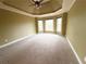 Empty bedroom features a decorative ceiling, carpeted floors, and windows providing ample natural light at 7020 Grassmoor Grange Way, Cumming, GA 30040