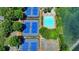 Aerial view showcasing community pool, tennis courts and algae covered pond at 7020 Grassmoor Grange Way, Cumming, GA 30040
