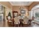 Elegant dining room with chandelier, large window, and dining table with upholstered chairs at 7020 Grassmoor Grange Way, Cumming, GA 30040