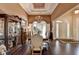 Formal dining room featuring a chandelier, hardwood floors, large windows, and classic furnishings at 7020 Grassmoor Grange Way, Cumming, GA 30040