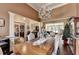 Spacious dining room with a grand table set, showcasing an elegant chandelier and hardwood floors at 7020 Grassmoor Grange Way, Cumming, GA 30040