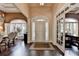 Grand foyer with dark wood floors, arched doorway, and transom windows, offering a welcoming entrance at 7020 Grassmoor Grange Way, Cumming, GA 30040