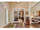 Inviting foyer with hardwood floors, decorative rug, and glass paneled doors leading to other rooms at 7020 Grassmoor Grange Way, Cumming, GA 30040