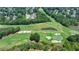 Aerial view of a meticulously maintained golf course featuring lush green fairways and scenic landscaping at 7020 Grassmoor Grange Way, Cumming, GA 30040