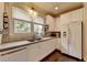 Bright kitchen features stainless steel appliances, granite countertops, and abundant white cabinetry at 7020 Grassmoor Grange Way, Cumming, GA 30040