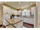 Spacious kitchen boasts granite countertops, stainless steel appliances, and a convenient island with seating at 7020 Grassmoor Grange Way, Cumming, GA 30040