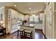 Well-lit kitchen with white cabinetry, granite countertops, and a central island at 7020 Grassmoor Grange Way, Cumming, GA 30040