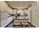 Charming kitchen with white cabinets, granite countertops and island seating at 7020 Grassmoor Grange Way, Cumming, GA 30040