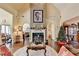 Cozy living room features a fireplace, hardwood floor, and neutral walls at 7020 Grassmoor Grange Way, Cumming, GA 30040