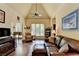 Bright and airy living room with hardwood floors, vaulted ceiling, and a view to the outdoors at 7020 Grassmoor Grange Way, Cumming, GA 30040