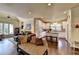 Open-concept living room, featuring hardwood floors and a view of the kitchen at 7020 Grassmoor Grange Way, Cumming, GA 30040
