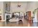 Spacious living room with fireplace, hardwood floors, and high ceilings provides elegant comfort at 7020 Grassmoor Grange Way, Cumming, GA 30040