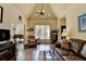 Bright living room with hardwood floors, vaulted ceiling, and large windows offering scenic views at 7020 Grassmoor Grange Way, Cumming, GA 30040