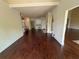 Expansive living area with hardwood floors connecting to the kitchen and dining spaces at 7020 Grassmoor Grange Way, Cumming, GA 30040