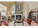 Open living room with fireplace, bright, airy spaces, and views to other rooms at 7020 Grassmoor Grange Way, Cumming, GA 30040