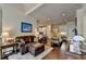 Inviting living room with hardwood floors, leather sofa, and neutral decor at 7020 Grassmoor Grange Way, Cumming, GA 30040