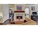 Spacious living room featuring a fireplace and open access to multiple rooms at 7020 Grassmoor Grange Way, Cumming, GA 30040