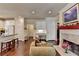 Cozy living area with a fireplace, hardwood flooring, and white cabinets at 7020 Grassmoor Grange Way, Cumming, GA 30040
