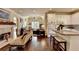 Open-concept layout showcasing the kitchen, living room, and hardwood floors throughout at 7020 Grassmoor Grange Way, Cumming, GA 30040