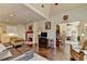 Open living area with hardwood floors, fireplace, and a view into other rooms, creating an inviting space at 7020 Grassmoor Grange Way, Cumming, GA 30040