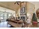 Expansive living room with soaring ceilings, a cozy fireplace, and a comfortable seating arrangement at 7020 Grassmoor Grange Way, Cumming, GA 30040