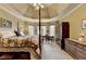 Large primary bedroom featuring natural light, a decorative ceiling, and hardwood furniture at 7020 Grassmoor Grange Way, Cumming, GA 30040