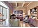 Well-lit home office with coffered ceilings, built-in shelving and a large desk with leather accents at 7020 Grassmoor Grange Way, Cumming, GA 30040
