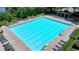Large outdoor swimming pool surrounded by lounge chairs and greenery at 7020 Grassmoor Grange Way, Cumming, GA 30040