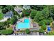 Aerial view of a community pool surrounded by lush greenery and residential homes at 7020 Grassmoor Grange Way, Cumming, GA 30040