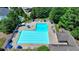 Aerial view of a community pool with lounge chairs and umbrellas at 7020 Grassmoor Grange Way, Cumming, GA 30040