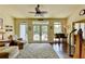 Sun room features door, sofa, and hardwood floor at 7020 Grassmoor Grange Way, Cumming, GA 30040