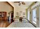 Sun room features chairs, hardwood floor, and natural light at 7020 Grassmoor Grange Way, Cumming, GA 30040