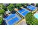 Aerial view of community tennis courts and parking area, showcasing well-maintained facilities and landscaping at 7020 Grassmoor Grange Way, Cumming, GA 30040